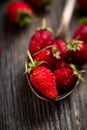 Red ripe wild strawberry in old vintage spoon on the rustic background Royalty Free Stock Photo