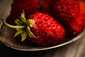 Red ripe wild strawberry in old vintage spoon on the rustic background Royalty Free Stock Photo