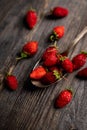 Red ripe wild strawberry in old vintage spoon on the rustic background Royalty Free Stock Photo