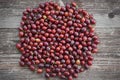 Red riped gooseberries on the vintage wooden table