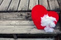 Ripped stuffed heart lying on old wooden steps