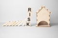 Red RISK cube blocks stop falling blocks protect house miniature. fall Business, Home Insurance, investment, Crisis, Economic