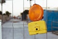 red road construction lamp on the fence indicating attention to work in progress Royalty Free Stock Photo