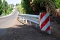 red road reflectors along the road. metal road fencing of barrier type, close-up. Road and traffic safety. reflective