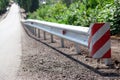 red road reflectors along the road. metal road fencing of barrier type, close-up. Road and traffic safety. reflective