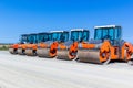 Red road rollers parked on the unfinished road construction site Royalty Free Stock Photo