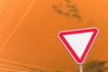 Red road sign isolated. Defocus blank empty triangle red warning road sign with on orange background. Danger direction Royalty Free Stock Photo