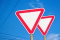 Red road sign isolated. Defocus two blank empty triangle red warning road signs with blue sky background. Danger