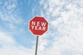 Red road sign with a text of new year under sky Royalty Free Stock Photo