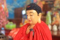 red robed meditating buddha statue