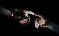 Red robot hand making contact with human hand 3D rendering