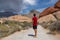 Red Rock Canyon - Man on Sandstone Quarry Overlook path with scenic view of summit Turtlehead Peak of La Madre mountains, Nevada Royalty Free Stock Photo