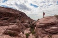 Red Rock Canyon - Woman standing on edge of rock formation with scenic view of limestone rock of Calico Hills, Nevada, USA