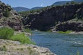 Red rock green river riverbank Royalty Free Stock Photo