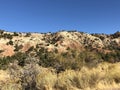 Red rock rock and limestone hills hills with pine tress, brush under brilliant blue skies. Cedar City, Southern Utah Royalty Free Stock Photo