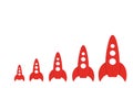 Red rockets are in order of increasing on a white background. The concept of space and technology, travel to the stars and other p Royalty Free Stock Photo