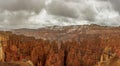 Red rocks under the cloudy sky in the Bryce Canyon National Park, Utah, the USA on a gloomy day Royalty Free Stock Photo