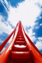 Red roller coaster with a blue sky in the background Royalty Free Stock Photo