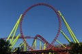 Red roller coaster loop with yellow pillars