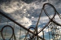 Red roller coaster track with a dark cloudy sky Royalty Free Stock Photo