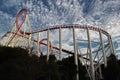 Red roller coaster track with a dark cloudy sky Royalty Free Stock Photo