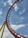 Red roller coaster track loop against a bright blue sky Royalty Free Stock Photo