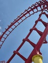 Red roller coaster track loop against a bright blue sky Royalty Free Stock Photo