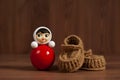 Red roly-poly doll and crochet baby booties Royalty Free Stock Photo