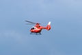 Red Romanian emergency services helicopter in the sky at Iasi rally event