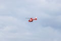 Red Romanian emergency services helicopter in the sky at Iasi rally event