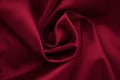 Red romantic fabric background. Folds of silk, dark satin, creases textile, natural pattern, shiny texture of cloth Royalty Free Stock Photo