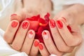 Red romantic manicure and petals. Royalty Free Stock Photo