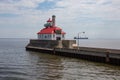 Red Roof Lighthouse with Cargo ship passing