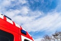 Red roof of a medicalized ambulance over blue sky with clouds and copy space, to care for pandemic sufferers