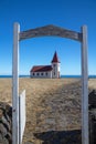 Red-roofed Hellnar church seen through a gate, Snaefellsnes, Ice