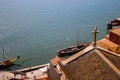 Red roofs with cross on river Douro background top view. Embankment with church roof and wooden cross in Porto, Portugal. Royalty Free Stock Photo