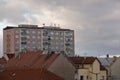 Red roofs and pink apartment building. Prefabricated house. Windows, balconies, roofs and chimneys Royalty Free Stock Photo