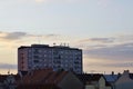 Red roofs and pink apartment building. Prefabricated house. Windows, balconies, roofs and chimneys. Antennas on the roofs Royalty Free Stock Photo