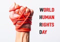 Red rope on fist hand with WORLD HUMAN RIGHTS DAY text on white background Royalty Free Stock Photo