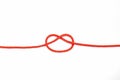 Red rope with a knot not completely tied on a white isolated background Royalty Free Stock Photo