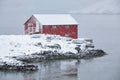 Red rorbu house in winter, Lofoten islands, Norway