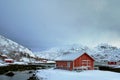 Red rorbu house in winter, Lofoten islands, Norway