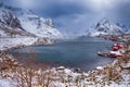 Red rorbu houses of Sakrisoy village with snow