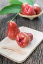 Red rose apple on wood plate Royalty Free Stock Photo