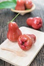 Red rose apple on wood plate Royalty Free Stock Photo