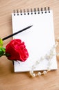 Red rose and blank diary. Royalty Free Stock Photo