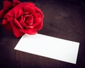 Red rose and blank gift card for text on old wood background Royalty Free Stock Photo