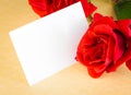 Red rose and blank gift card for text on parchment paper background