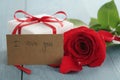 Red rose on blue wood table with gift and i love you paper card Royalty Free Stock Photo