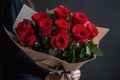 red rose bouquet being presented to special person, with romantic and sweet gesture